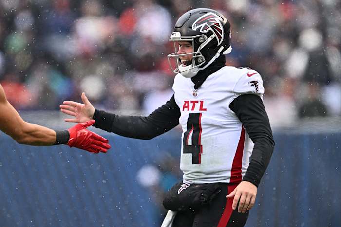 Dec 31, 2023; Chicago, Illinois, USA; Atlanta Falcons quarterback Taylor Heinicke (4) celebrates after throwing a 75-yard touchdown pass in the first half against the Chicago Bears at Soldier Field.